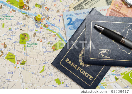 ARgentine passports and different money on a map planning a vacation. Vacation concept, travel. Copy space 95339417