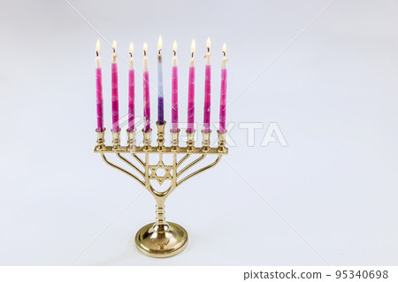 Candles lit in Menorah Hanukkah festival symbols with white background and copy space for holiday symbols Candles lit in Menorah Hanukkah festival symbols with white background and copy space for holiday symbols 95340698