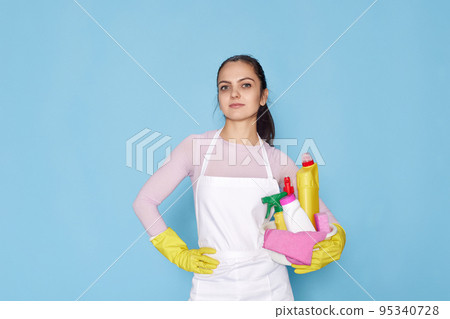 woman in gloves holding bucket with cleaning supplies 95340728