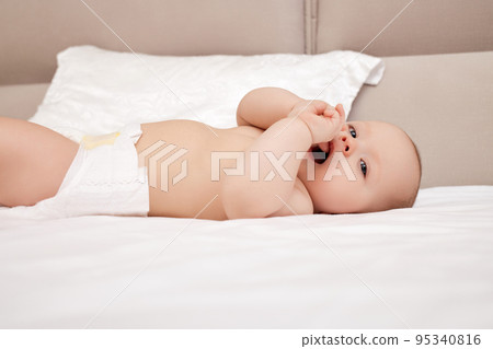 newborn baby girl in the white bed 95340816