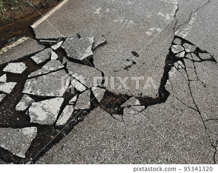 decayed road paved asphalt distressed road surface with damaged, peeling damaged road waiting for road repair roadway 95341320