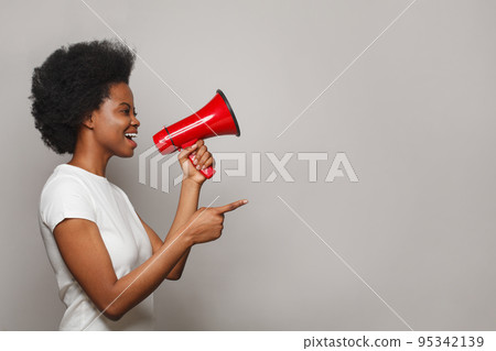 Black model woman with red loudspeaker. Leadership, attention, advertisement, broadcasting Black model woman with red loudspeaker. Leadership, attention, advertisement, broadcasting 95342139