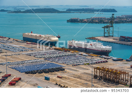 [Logistics] Car carrier docked at a container terminal Daytime 95343703