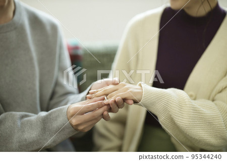 Proposal image A couple's hand holding a ring Proposal image A couple's hand holding a ring 95344240