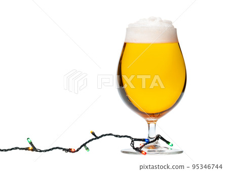 Tulip glass of beer with christmas lights isolated Tulip glass of beer with christmas lights isolated 95346744
