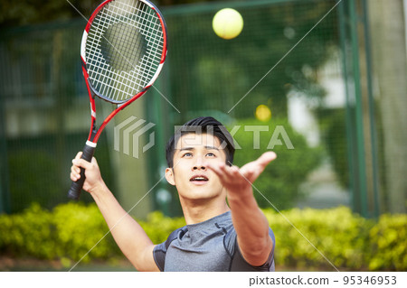 young asian adult man playing tennis 95346953