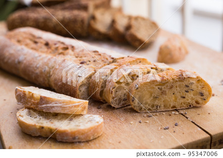 fresh loaf of bread on wooden board 95347006