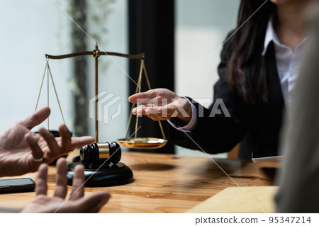 Business people and lawyers discussing contract papers with brass scale on wooden desk in office. Law, legal services, advice, Justice concept Business people and lawyers discussing contract papers with brass scale on wooden desk in office. Law, legal services, advice, Justice concept 95347214