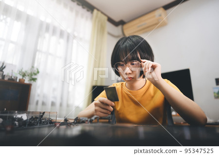 Young adult asian woman solo playing board game on top table. 95347525