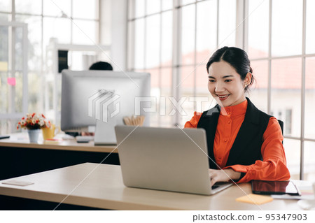 Business woman working in office and social distance work table. Business woman working in office and social distance work table. 95347903