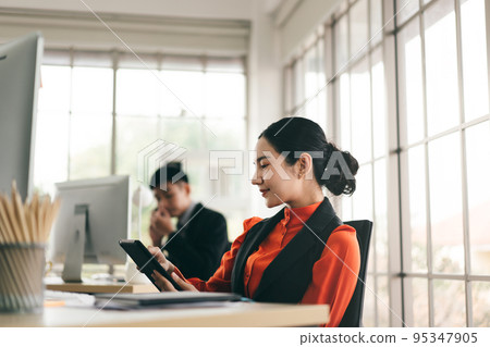 Adult business woman use tablet to check notification stock market. Adult business woman use tablet to check notification stock market. 95347905