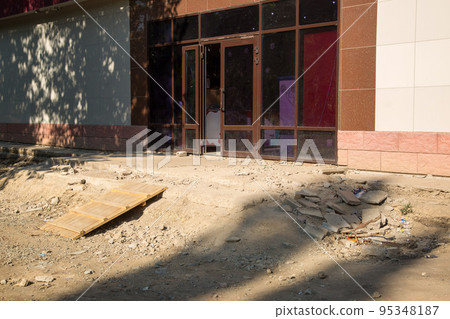 Destroyed entrance to the building, fragments of stairs and debris Destroyed entrance to the building, fragments of stairs and debris 95348187