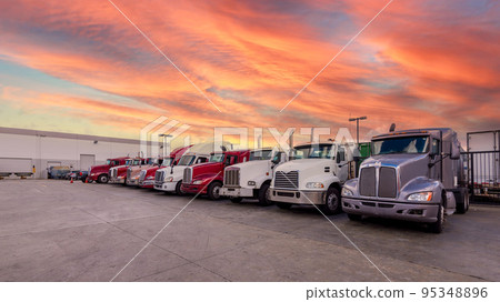 Semi-trailers lined up at the warehouse berth at dusk Semi-trailers lined up at the warehouse berth at dusk 95348896