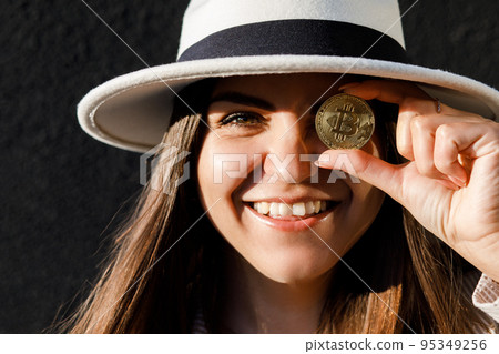 Beautiful girl in glasses from bitcoin. Bitcoin cryptocurrency. Sexy woman with bitcoin isolated on outdoor. Bull market. 95349256