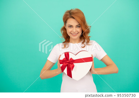 happy woman hold heart present box on blue background happy woman hold heart present box on blue background 95350730