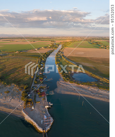 Nice aerial view of typical fishing huts at sunset near Ravenna 95352053