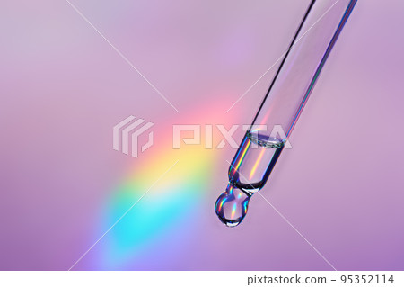 Pipette with cosmetic product on holographic background, iridescent highlights, selective focus Pipette with cosmetic product on holographic background, iridescent highlights, selective focus 95352114