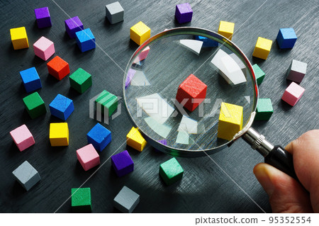 The hand is holding a magnifying glass. Talent acquisition concept. 95352554