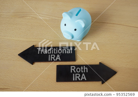 Blue piggy bank and arrows Traditional and Roth IRA. 95352569