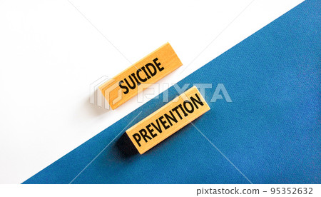 Suicide prevention symbol. Concept words Suicide prevention on wooden blocks. Beautiful white and blue background. White and blue paper. Psychological and suicide prevention concept. Copy space. 95352632