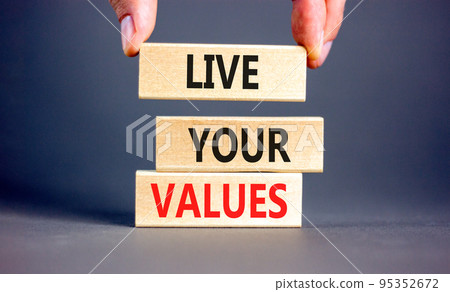 Live your values symbol. Concept words Live your values on wooden blocks. Businessman hand. Beautiful grey table grey background. Business, psychological and live your values concept. Copy space. Live your values symbol. Concept words Live your values on wooden blocks. Businessman hand. Beautiful grey table grey background. Business, psychological and live your values concept. Copy space. 95352672