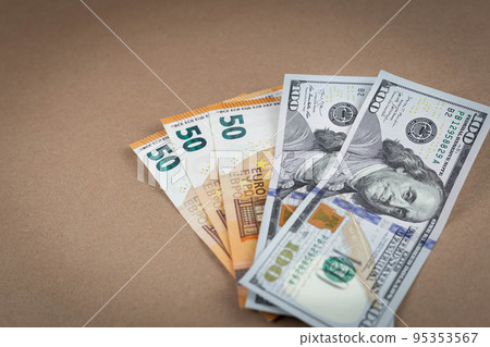 Paper money banknotes dollars and euros on a brown background with a vintage paper texture. Close up. Copy Space. Grunge 95353567