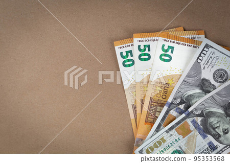 Paper money banknotes dollars and euros on a brown background with a vintage paper texture. Close up. Copy Space. Grunge Paper money banknotes dollars and euros on a brown background with a vintage paper texture. Close up. Copy Space. Grunge 95353568