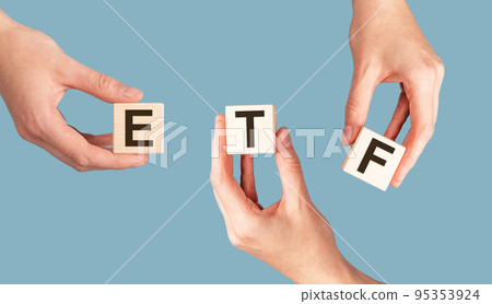 ETF acronym on cubes in hands. Investment asset 95353924