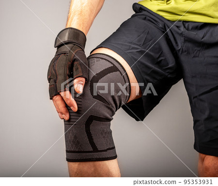 Athlete touching hurting knee, kneecap after sport trauma Athlete touching hurting knee, kneecap after sport trauma 95353931