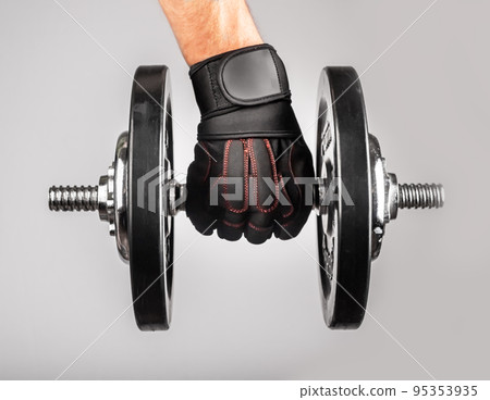 Hand holding heavy dumbbell 95353935