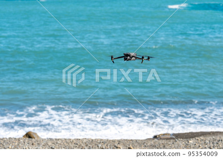 Drone flying on the shore 95354009