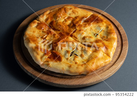 traditional georgian bread khachapuri on wooden board on black background 95354222