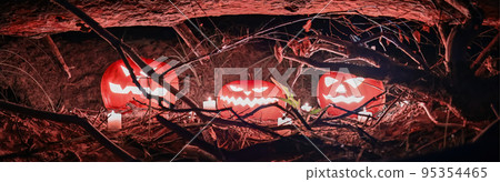 Panorama of Halloween pumpkin heads, surrounded by burning candles and dry branches, in scary deep night forest. Jack-o'-latern. Spooky Halloween holiday concept 95354465
