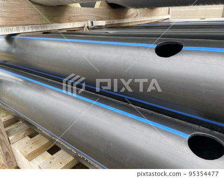 Large plastic pipes of large diameter with flanges in an open-air storage warehouse for the storage of materials and industrial equipment Large plastic pipes of large diameter with flanges in an open-air storage warehouse for the storage of materials and industrial equipment 95354477