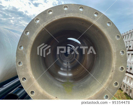Large diameter plastic polypropylene pipe with flange in open air storage warehouse for storage of materials and industrial equipment Large diameter plastic polypropylene pipe with flange in open air storage warehouse for storage of materials and industrial equipment 95354478