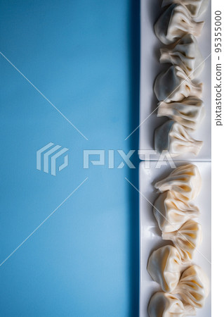 traditional georgian khinkali dumplings flatlay with copyspace, blue background traditional georgian khinkali dumplings flatlay with copyspace, blue background 95355000