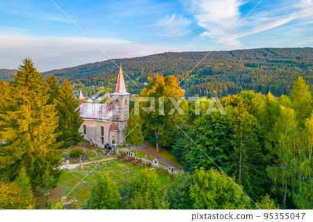 Rural catholic church from above 95355047