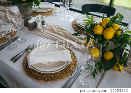 Festive table at the wedding party decorated with lemon arrangements 95355833