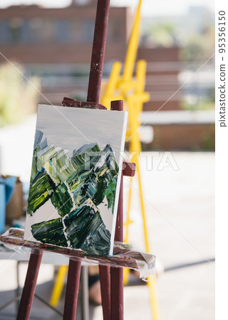 The unfinished painting on a wooden easel. The unfinished painting on a wooden easel. 95356150