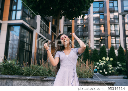 Woman on the background of large building Woman on the background of large building 95356314