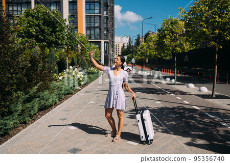 Young woman taking selfies on a phone. Young woman taking selfies on a phone. 95356740