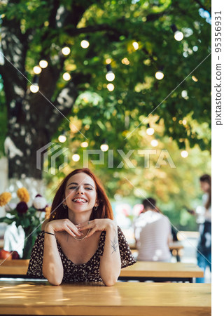 Close-up portrait of two female at summer street cafe 95356931