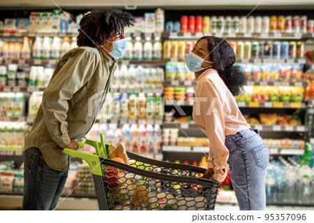 Black Spouses Shopping Having Fun Riding On Cart In Supermarket 95357096