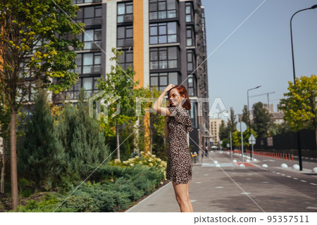Cute girl talking on mobile phone on modern city background 95357511
