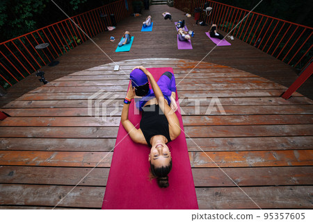 Group of young sporty people practicing yoga lesson with instructor, Group of young sporty people practicing yoga lesson with instructor, 95357605