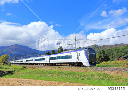 Limited express Azusa going to the foot of Mt.Hakuba in autumn Limited express Azusa going to the foot of Mt.Hakuba in autumn 95358155
