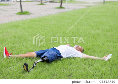 Disabled man with prosthetic leg 95358239
