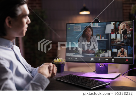 Asian man talking to colleagues on videoconference, attending business meeting online on teleconference call. Usin webcam on computer to chat with people on internet videocall connection. Asian man talking to colleagues on videoconference, attending business meeting online on teleconference call. Usin webcam on computer to chat with people on internet videocall connection. 95358252
