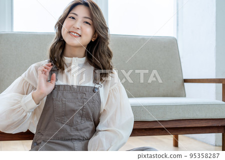 Young woman relaxing in her room Young woman relaxing in her room 95358287