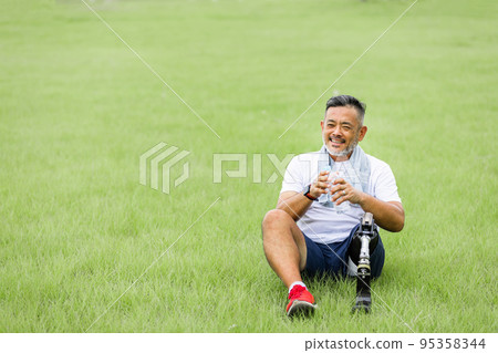 Disabled man with prosthetic leg 95358344